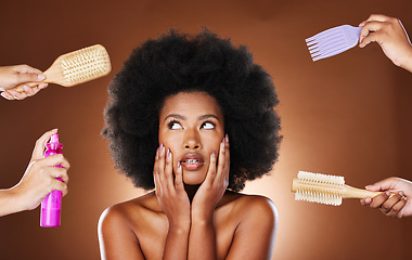 Image showing Haircare, hairspray and brush with a model black woman in studio with a choice of care for afro hair in hands. Beauty, cosmetics and backstage with an attractive young female on a brown background