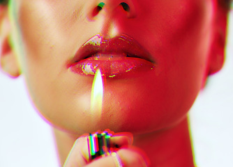 Image showing Makeup, beauty and woman with mouth lighter flame for an edgy, gen z and futuristic cosmetic campaign. Neon hologram face effect on shiny lip gloss cosmetics model zoom in white studio.