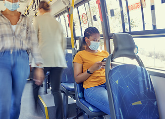 Image showing Travel, covid and woman on a bus with face mask for compliance, safety and bacteria protection in a city. Corona, public transport and girl riding busy transportation downtown during global pandemic