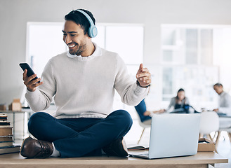 Image showing Asian businessman, headphones or phone music in digital marketing, advertising or creative design office. Smile, happy or cross legged entrepreneur listening to fun or motivation mobile radio podcast