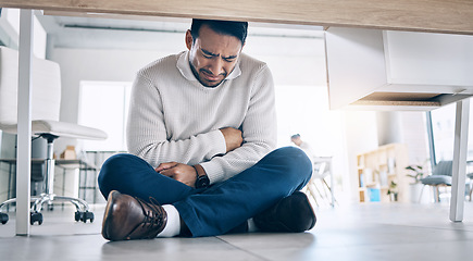 Image showing Business stress, crying and burnout of a office employee suffering from mental health breakdown. Company business man with stomach pain and sad feeling under corporate desk with depression from work