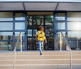 Image showing Child, walking and school entrance for education, learning or childhood development at academy building. Kid having a walk up the steps ready for back to school morning with backpack for knowledge