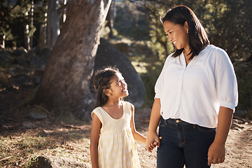 Image showing Happy, child and mother walking in nature holding hands, bonding or talking as mother and daughter outdoors. Smile, happy family and young girl enjoys quality time with a lovely mama or mom in Peru