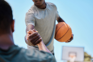 Image showing Basketball, help and team on a court playing a match, training or practicing together for a competition. Fitness, sports and man helping his friend on a basketball court during a game or practice.