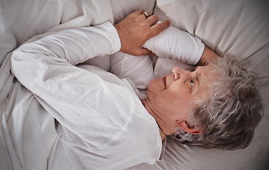 Image showing Senior woman, bed and insomnia stress in house while tired, worry and anxiety in retirement. Elderly lady, home bedroom and mental health with headache, frustrated and fail to sleep in nursing home