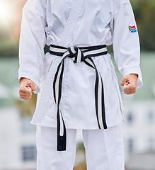 Image showing Karate, fitness and body of woman in martial arts training for competition with hands fist, fight and commitment in Japanese culture. Power, challenge and energy of sports person in taekwondo contest