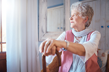Image showing Senior woman, cane and thinking in home, nostalgic or contemplating old memory. Disability, support and retired female with walking stick relaxing, focus or lost in thoughts alone in lonely house.