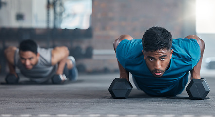 Image showing Fitness, dumbbell weights and men doing a push up exercise for strength, health and wellness in a gym. Sports, motivation and athletes doing a workout or training routine together in a sport center.