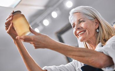 Image showing Elderly small business woman, hands and honey with smile for successful organic product in the retail store. Happy senior entrepreneur holding sweet glass jar and smiling for business career success