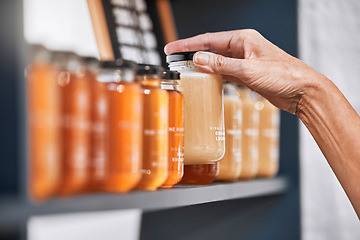 Image showing Hands, jar and honey shelf for inventory check, product pricing or labeling in organic retail store. Hand in small business, management or market advertising of healthy glass food products for sale