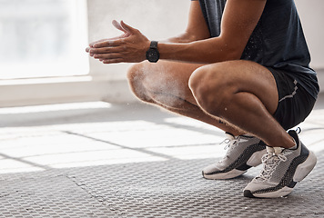 Image showing Man, powder and hands in gym for fitness, wellness or weightlifting while squat on rubber flooring. Healthy bodybuilder, chalk or ready for exercise workout, training or goal for strong body on floor