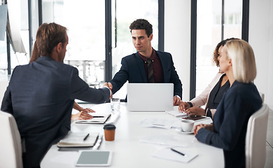 Image showing Business people, handshake and meeting for agreement, partnership or collaboration at office conference. Businessman shaking hands with employee in recruiting, team growth or hiring deal at workplace