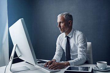 Image showing Computer, typing accountant and senior man in office, working on project online or mockup. Desktop, writing and serious manager at desk for reading email, research information or business auditor.