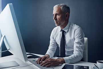 Image showing Computer, typing accountant and mature man in office, working and isolated on a studio background mockup. Tech, writing and serious manager at desktop for reading email, research or business auditor.