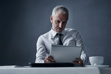 Image showing Tablet, accountant and mature business man in studio isolated on a dark background mockup space. Technology, reading and senior manager at desk for working on project, audit email or research app.