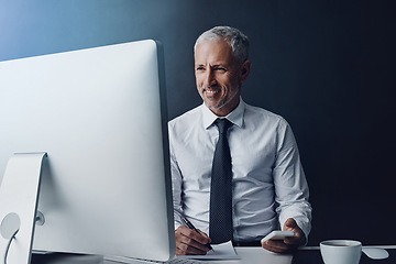 Image showing Writing, computer and business man at desk online for research, internet and browse website in office. Networking, corporate worker and mature male person on smartphone, write notes and planning