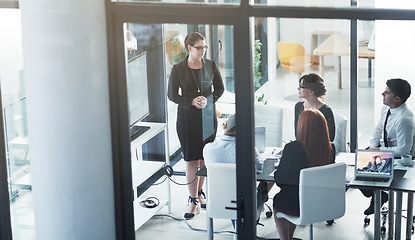 Image showing Business woman, presenter and monitor with group, team and information for strategy at finance company. Female manager, executive or boss with screen for coaching, training or collaboration in office