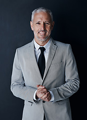 Image showing Studio portrait of senior businessman in suit, smile and handsome face on dark background. Confidence, pride and professional career for happy executive man or mature business owner or successful ceo