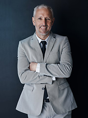 Image showing Portrait of confident, mature lawyer with suit, smile and arms crossed on dark background in studio. Happy, professional and executive attorney ceo or senior business owner at law firm with pride.