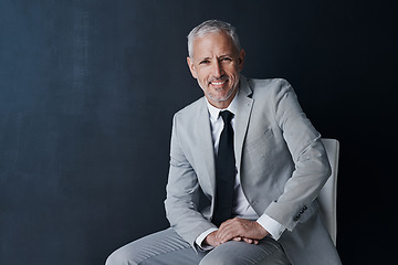 Image showing Studio portrait, happy businessman and chair in mockup space with confident boss on dark background. Smile, pride and professional career for executive, mature startup business owner or startup ceo.