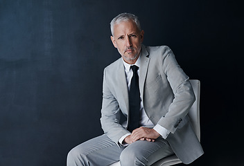 Image showing Studio portrait of senior businessman on chair in mockup, confidence and serious face on dark background. Space, pride and professional career for executive man, mature business owner or startup ceo.