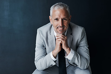 Image showing Happy portrait of senior attorney sitting with confidence, mockup space and dark background in studio. Pride, professional ceo and executive lawyer man with smile, mature businessman or law firm boss