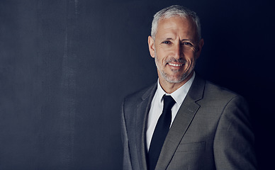 Image showing Mockup, smile and studio portrait of businessman in suit, confidence and pride on dark background. Boss, ceo and business owner with professional career, senior model with executive management job.