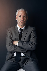 Image showing Portrait, chair and serious businessman with confidence, lawyer or attorney with on dark background in studio. Boss, ceo and professional business owner, senior director at law firm with arms crossed