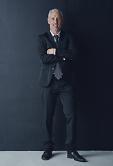 Image showing Studio portrait of mature businessman in suit, arms crossed and smile on dark background. Confidence, pride and professional career for happy executive man or senior business owner or successful ceo