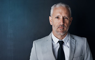 Image showing Senior executive, business man and headshot, portrait with confidence and management on dark background. Male CEO, corporate director in studio and suit with ambition, empowerment and mockup space