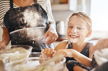 Image showing Flour, playing or portrait of girl baking in kitchen with a messy young kid smiling with a dirty face at home. Smile, happy or parent cooking or teaching a fun daughter to bake for child development