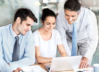 Image showing Business people, team and talking at laptop in office for planning, collaboration and discussion. Men and a woman leader together at desk with tech for tax, budget or brainstorming corporate strategy