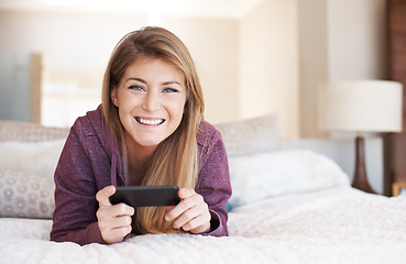 Image showing Teenager, girl in portrait and smartphone with games and relax in bedroom, smile with technology and esports. Young female person at home, gaming and mobile app with happiness, gen z and internet