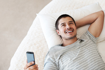 Image showing Man, happy and thinking with a phone on a bed for communication, chat or notification at home. Happy young person with a smartphone for message idea with internet connection, app and social media