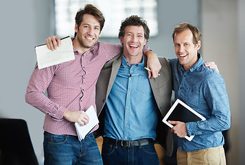 Image showing Team, portrait or business developers hug after meeting for support in office together with smile or unity. Confident men, people or happy programmers with technology, notes or notebook in workplace