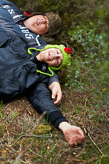 Image showing Drunk, hangover and boys with friends sleeping outdoor on a field together in the morning after a party. Grass, tired or alcoholism with a plus size man and friend asleep on the ground in a park