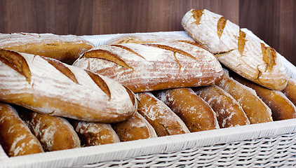 Image showing Bread in a basket, bakery presentation and food with baked goods, wheat product in store and catering. Baguette, hospitality industry with cafe or patisserie in France, nutrition and cuisine
