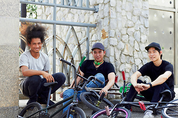 Image showing Portrait, bmx group and bicycle in city, outdoor and relax together in street. Cycling, people smile and happy friends with urban bike for sports, exercise or workout for fitness, health or wellness.