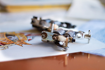 Image showing Creative, closeup and a tattoo gun for art, piercing or professional ink work in a studio. Creativity, tool and a machine or product for tattoos, artistic expression and needle for color on a desk