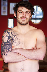 Image showing Happy, tattoo and portrait of a man with arms crossed for creativity, punk aesthetic and unique. Smile, morning and a person with pride, confidence and topless in a house with edgy style and body art