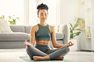 Image showing Woman, meditation and lotus pose on living room floor for peace, mental health and wellness at home. Yoga, breathing and exercise by female meditating in a lounge for zen, holistic or chakra training