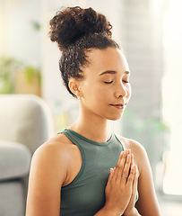 Image showing Praying hands, meditation and woman relax in living room for peace, wellness or mental health balance at home. Prayer pose, yoga and lady meditate in lounge for zen, healing or holistic exercise