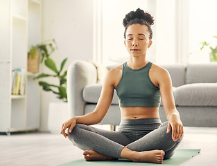 Image showing Meditation, woman and lotus pose on living room floor for peace, mental health and wellness at home. Yoga, breathing and exercise by female meditating in a lounge for zen, holistic or chakra training