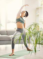 Image showing Yoga, wellness and woman in home with zen, relax and spiritual practice in a living room. Young female person, apartment and lounge with pilates and flexibility exercise in house feeling calm