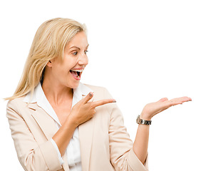 Image showing Wow, smile and mature woman with hand pointing in studio to exciting deal or promo on white background. Finger, omg and face of excited lady with product placement, coming soon sale or menu steps