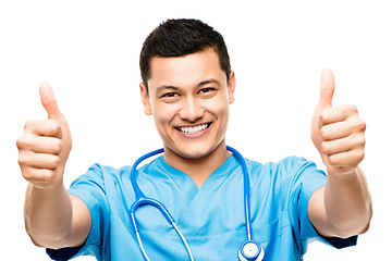 Image showing Thumbs up, pride and portrait of a male doctor in a studio for a medical consultation with confidence. Happy, smile and professional young man nurse with an approval hand gesture by white background.