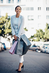 Image showing Happy woman, portrait and shopping bag in city street for fashion, style or purchase in the outdoors. Female person or shopper with smile for luxury spree on road in stylish clothing in an urban town