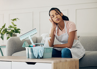 Image showing Cleaning, tired and exhausted woman in a house to clean with supplies, detergents or tools. Young female or cleaner in a lounge with headache or stress in an apartment or room with fatigue or problem