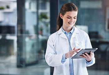 Image showing Telehealth, tablet or happy doctor in hospital with research on online media to search for medicine info. Woman, smile or medical healthcare professional browsing on technology for news in clinic