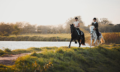 Image showing Horse riding, freedom and equestrian with friends in nature on horseback by the lake during a summer morning. Countryside, hobby and female riders outdoor together for travel, fun or adventure